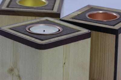 A collection of different decorated pine box tealight holders by Reuben's woodcraft