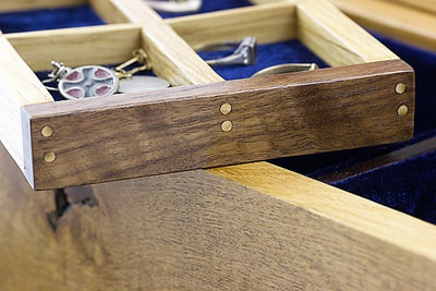 Small bamboo dowels set in walnut side of jewellery box tray